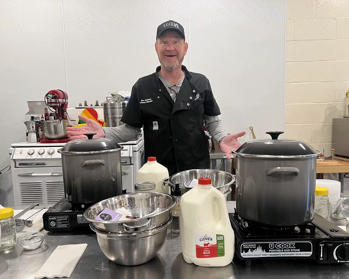 Ben prepares the ingredients and materials for a cheesemaking class