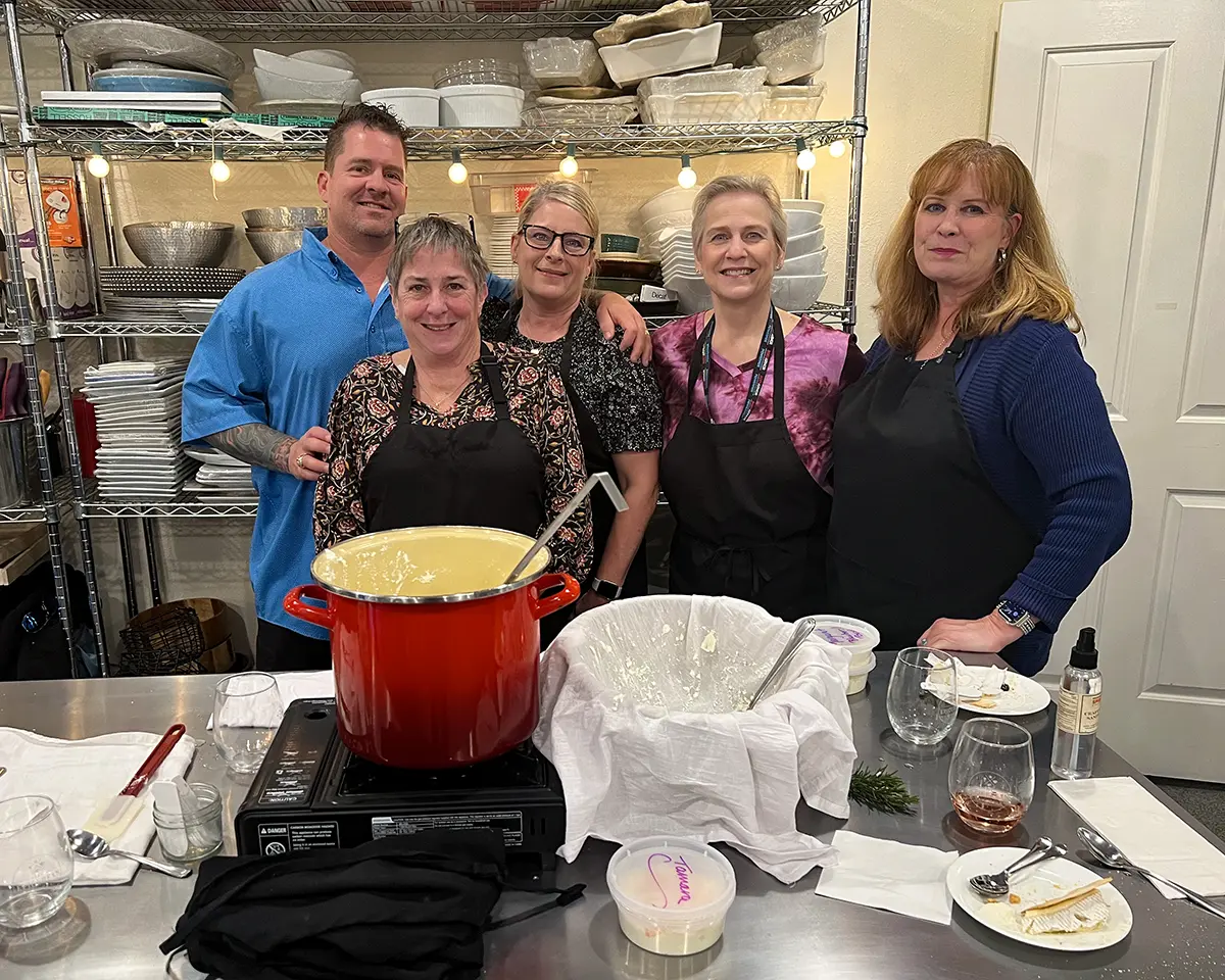 Four cheesemaking class students pose with Sheana Davis after a class