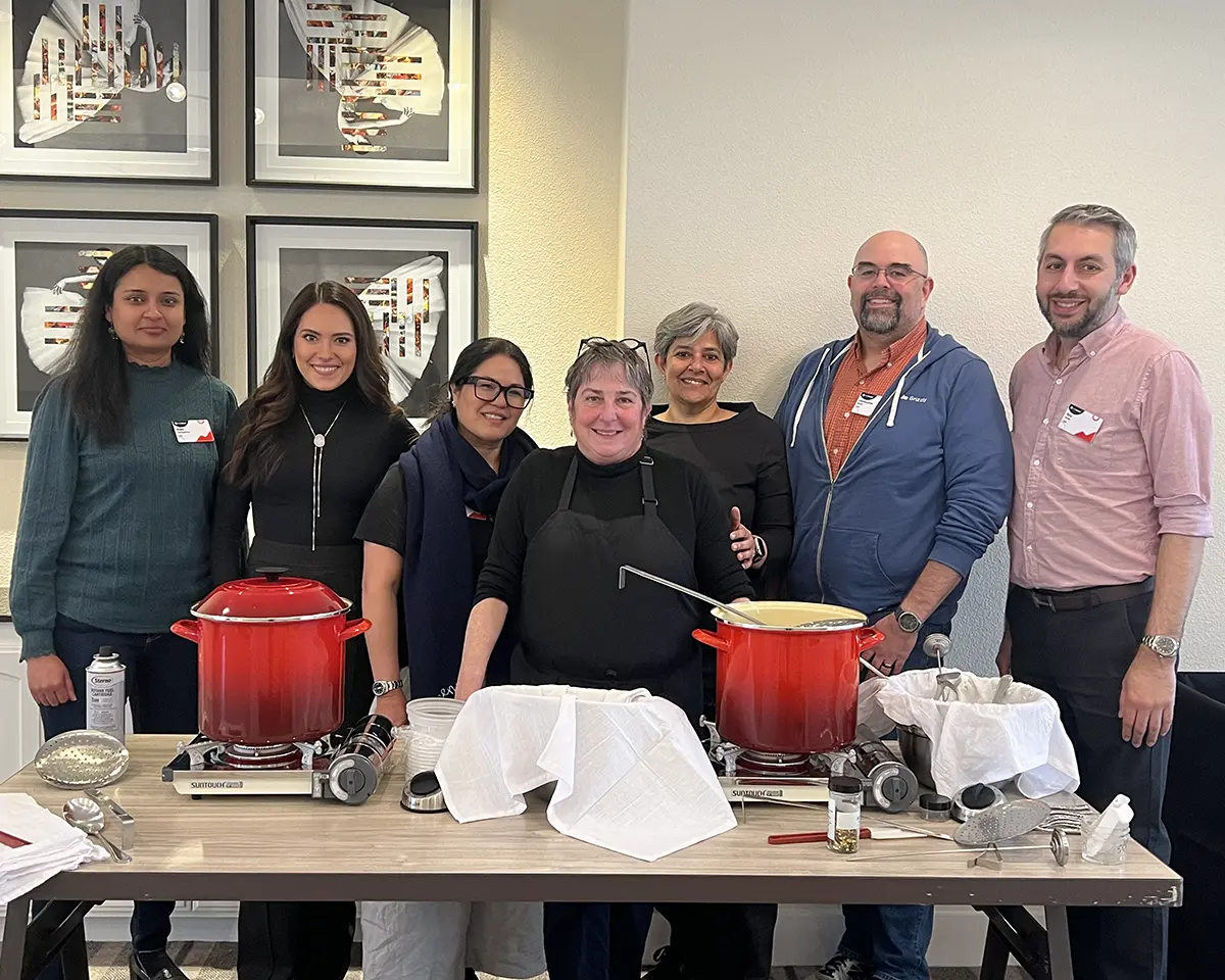 A private cheesemaking class at a local hotel pose with Sheana Davis