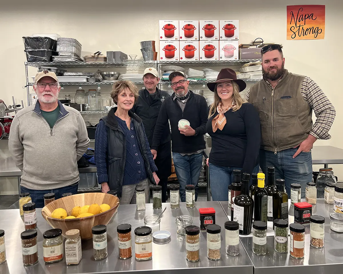 A family poses for a picture after taking a cheesemaking class together