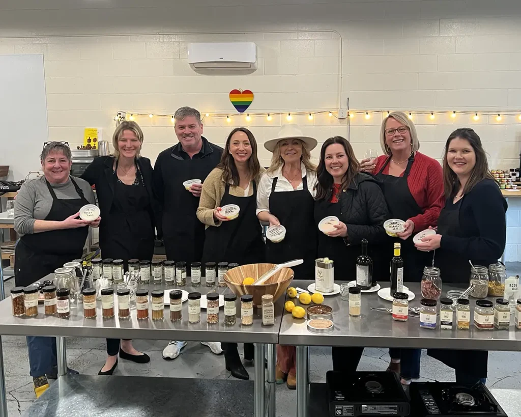 Eight students pose with Sheana after making cheese and butter
