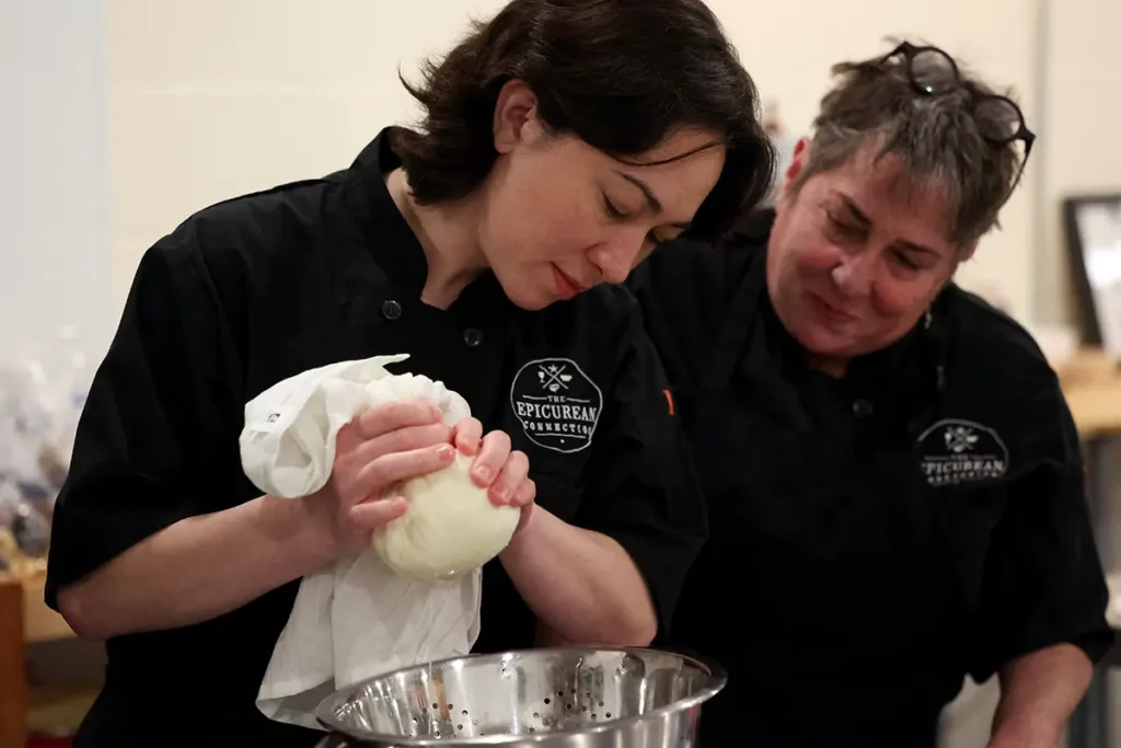 Closeup of Karina and Sheana Davis making butter in The Epicurean Connection kitchen
