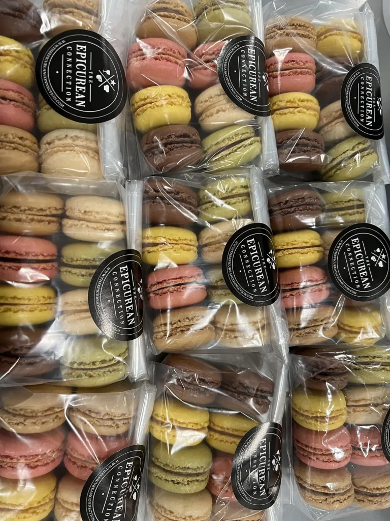 Macrons in various flavors pre-packaged with The Epicurean Connection branded labels