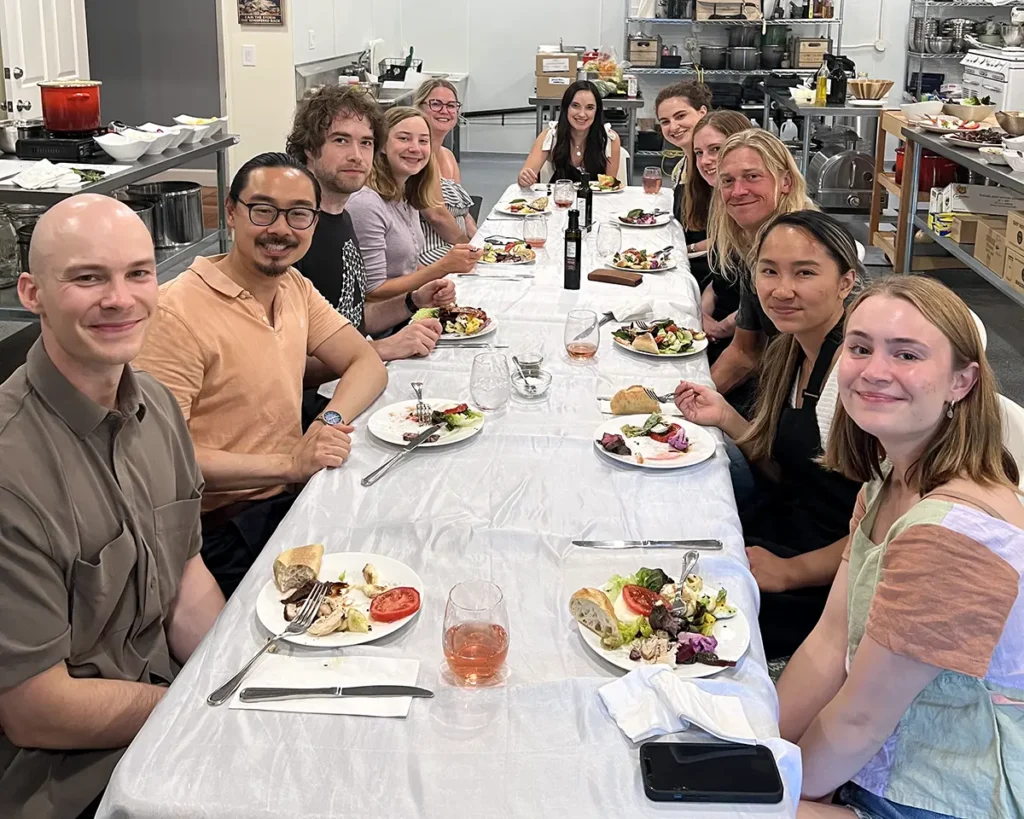 A cheesemaking class sits for a catered lunch at The Epicurean Connection
