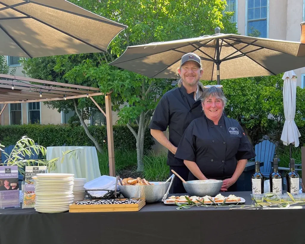 Ben Sessions and Sheana Davis pose for a picture at a catering event