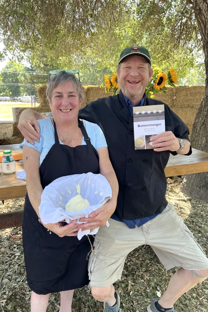 Sheana Davis and Ben Sessions pose with fresh butter and her Buttermonger book at the Gravenstein Apple Fair in Sebastopol, California